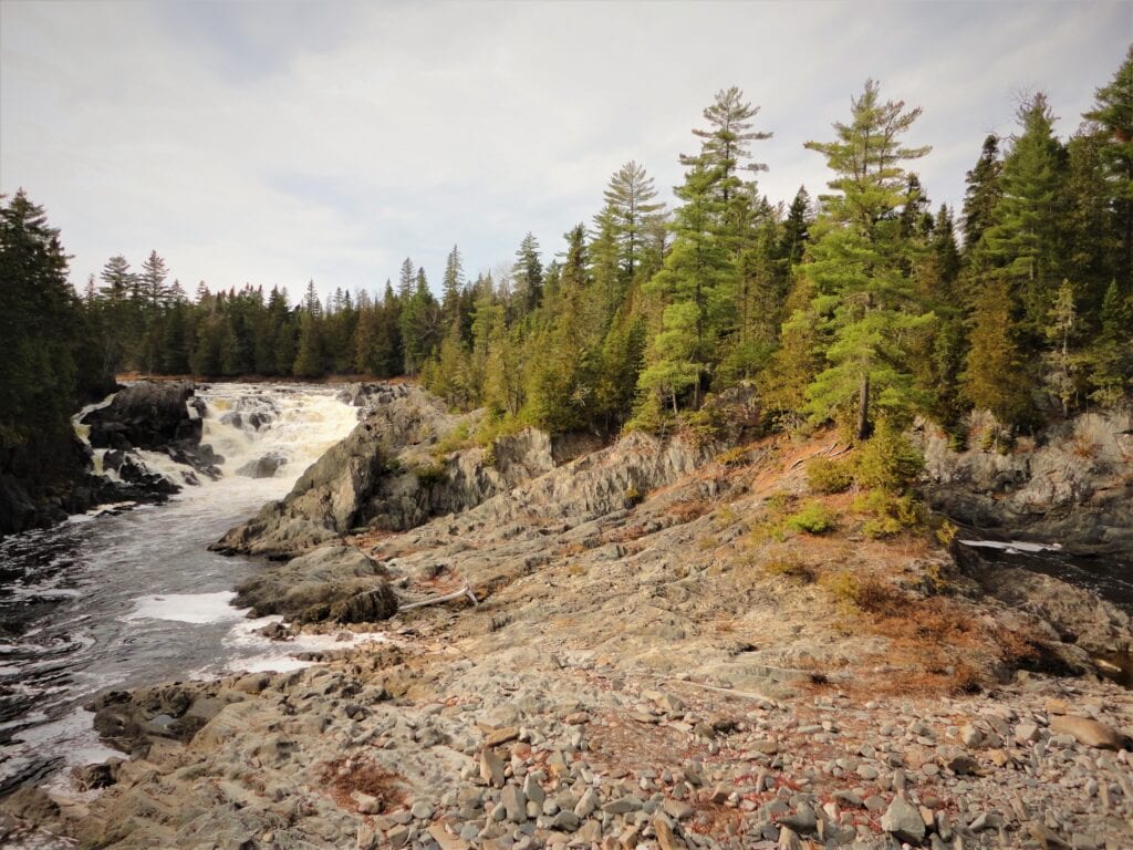 photo of alagash rocky waterfall alongside forest