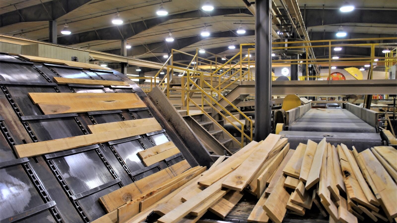 photo of wood manufacturing plant equipment creating boards