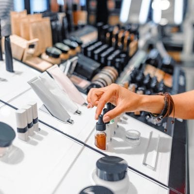 woman chooses cosmetics and make-up products in a store